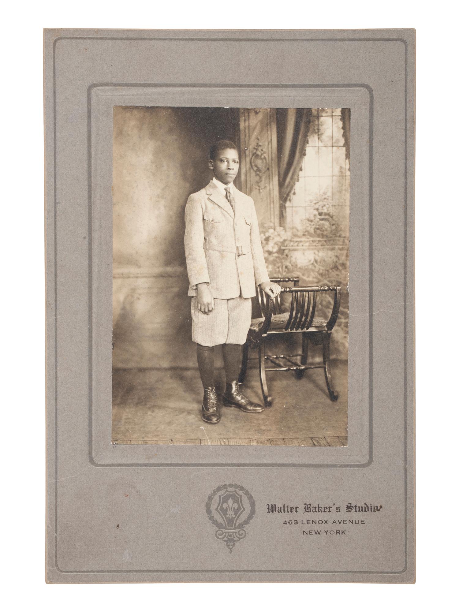[EARLY PHOTOGRAPHY]. Cabinet card of a young African American man taken at the studio of African American photographer Walter BAKER (ca 1877-1926). New York: ca 1920s.