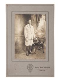 [EARLY PHOTOGRAPHY]. Cabinet card of a young African American man taken at the studio of African American photographer Walter BAKER (ca 1877-1926). New York: ca 1920s.