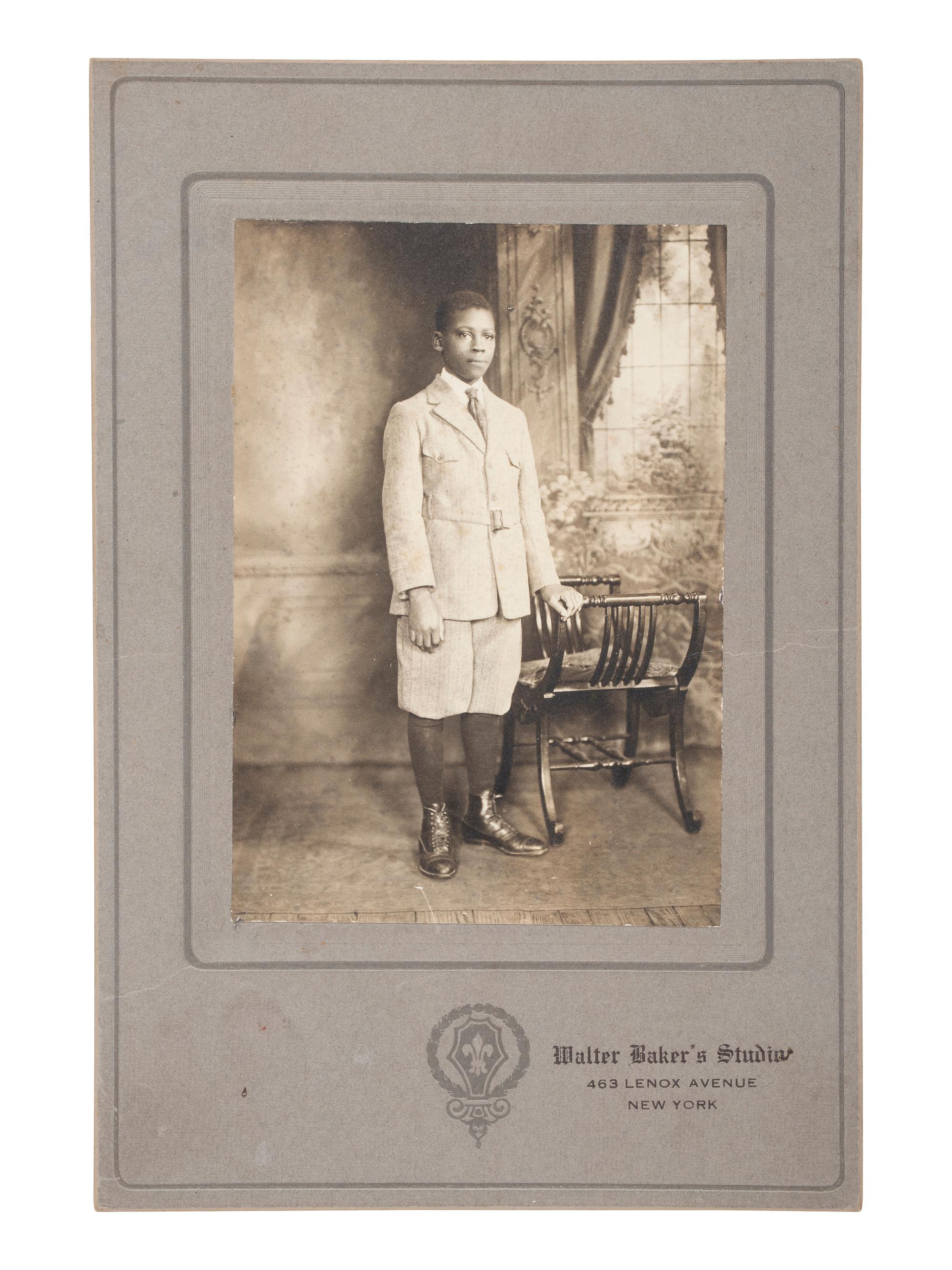 [EARLY PHOTOGRAPHY]. Cabinet card of a young African American man taken at the studio of African American photographer Walter BAKER (ca 1877-1926). New York: ca 1920s.