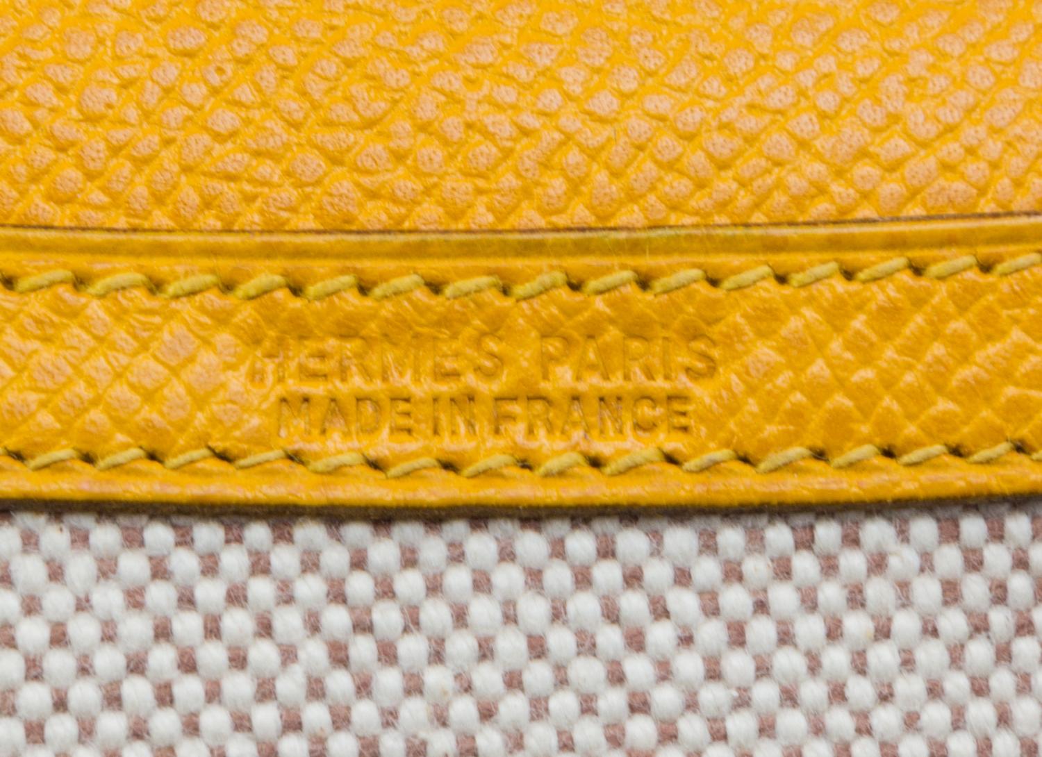 An Hermes Cream Toile and Yellow Leather Rio Clutch, 8.5" x 6" x 1.5".