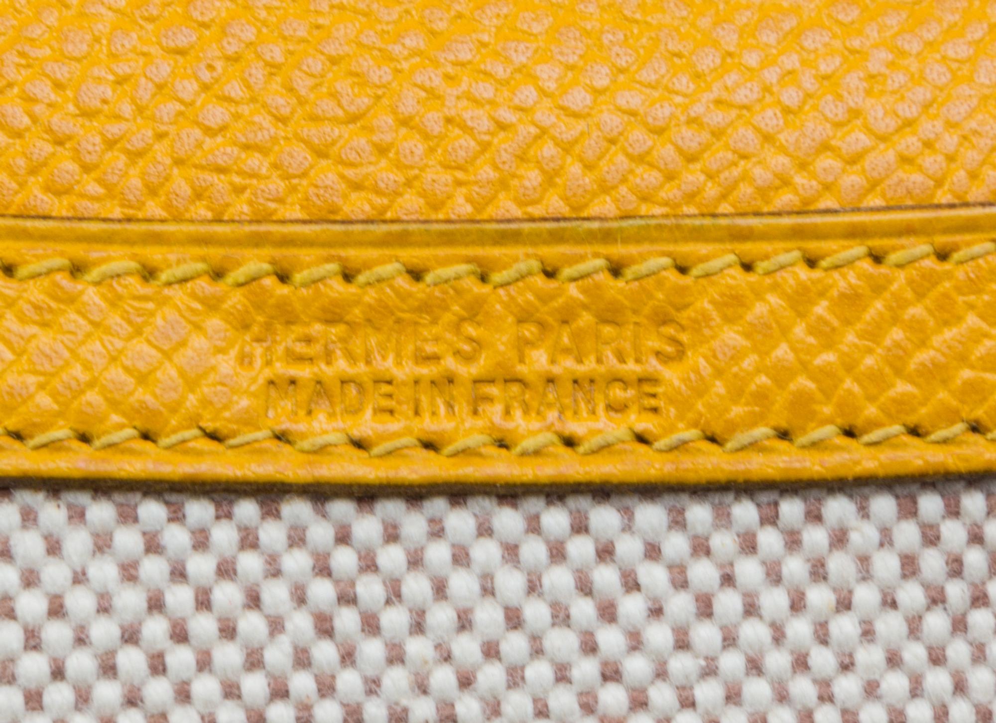 An Hermes Cream Toile and Yellow Leather Rio Clutch, 8.5" x 6" x 1.5".