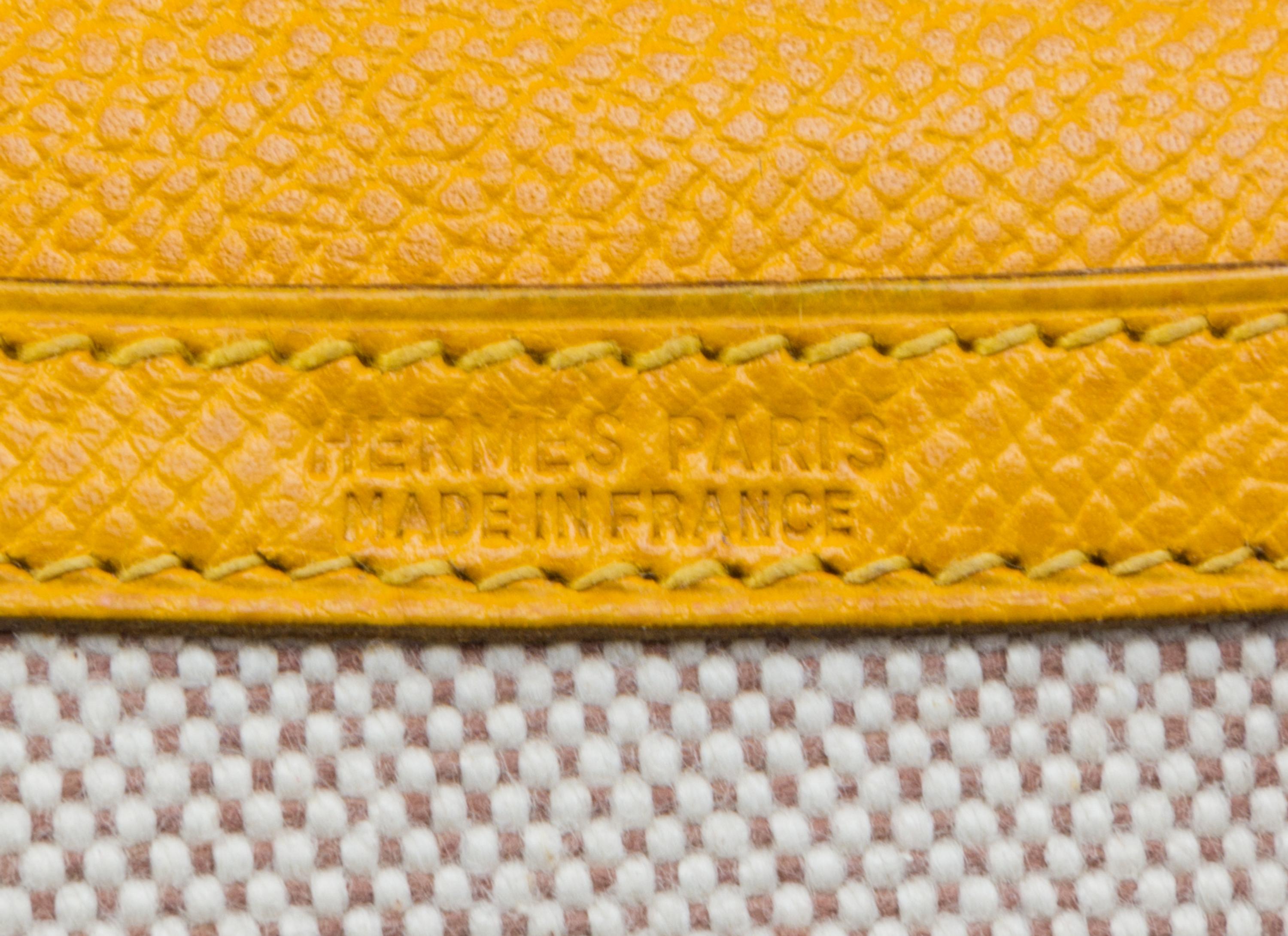 An Hermes Cream Toile and Yellow Leather Rio Clutch, 8.5" x 6" x 1.5".