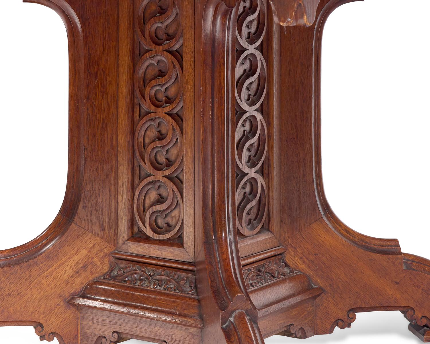 A Gothic Revival Carved Oak Center Table With Inset Leather Top