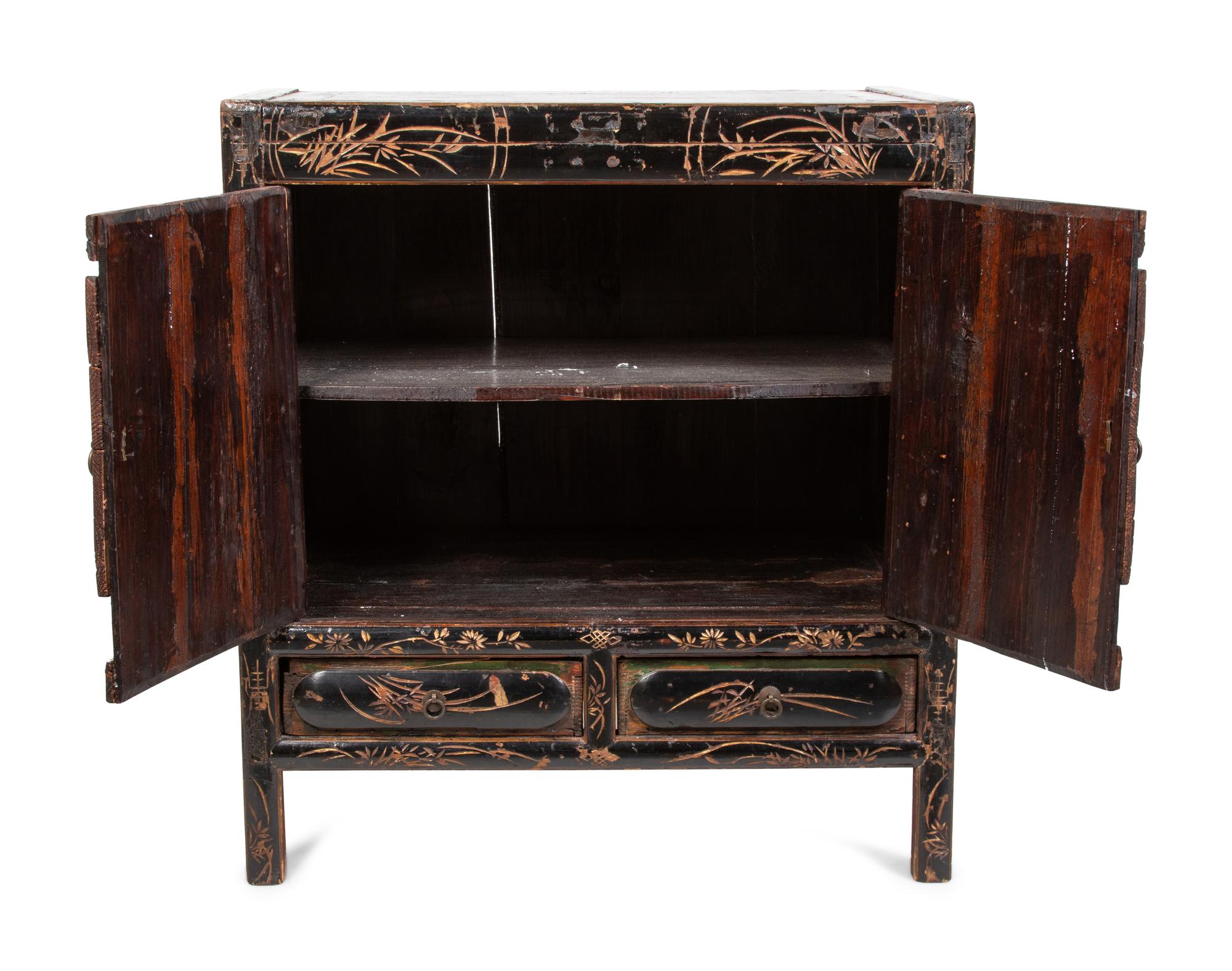 A Chinese Export Cabinet with Carved Lacquer Decoration