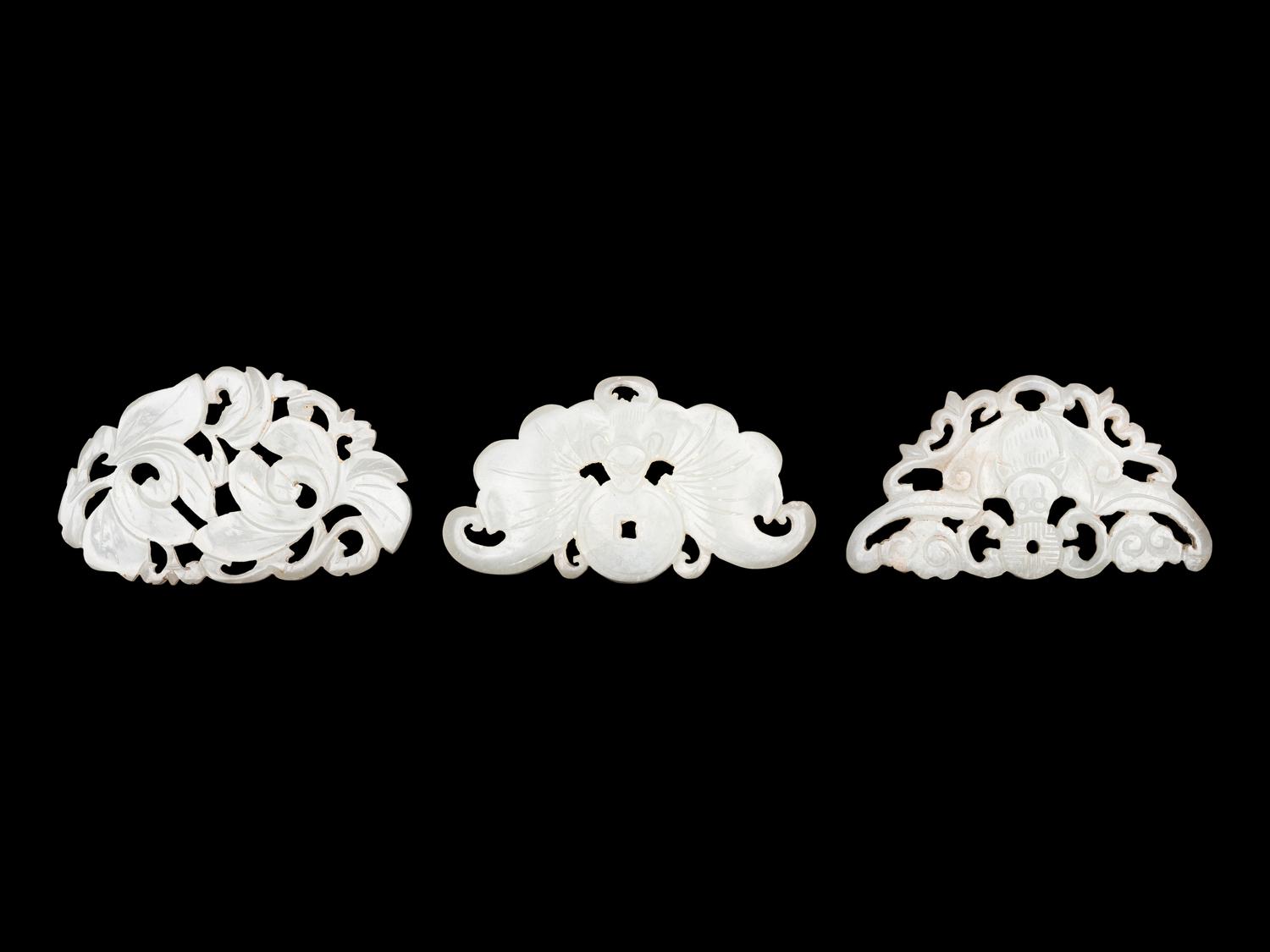 Three Chinese Pale Celadon Jade Reticulated Flori-Form Pendants