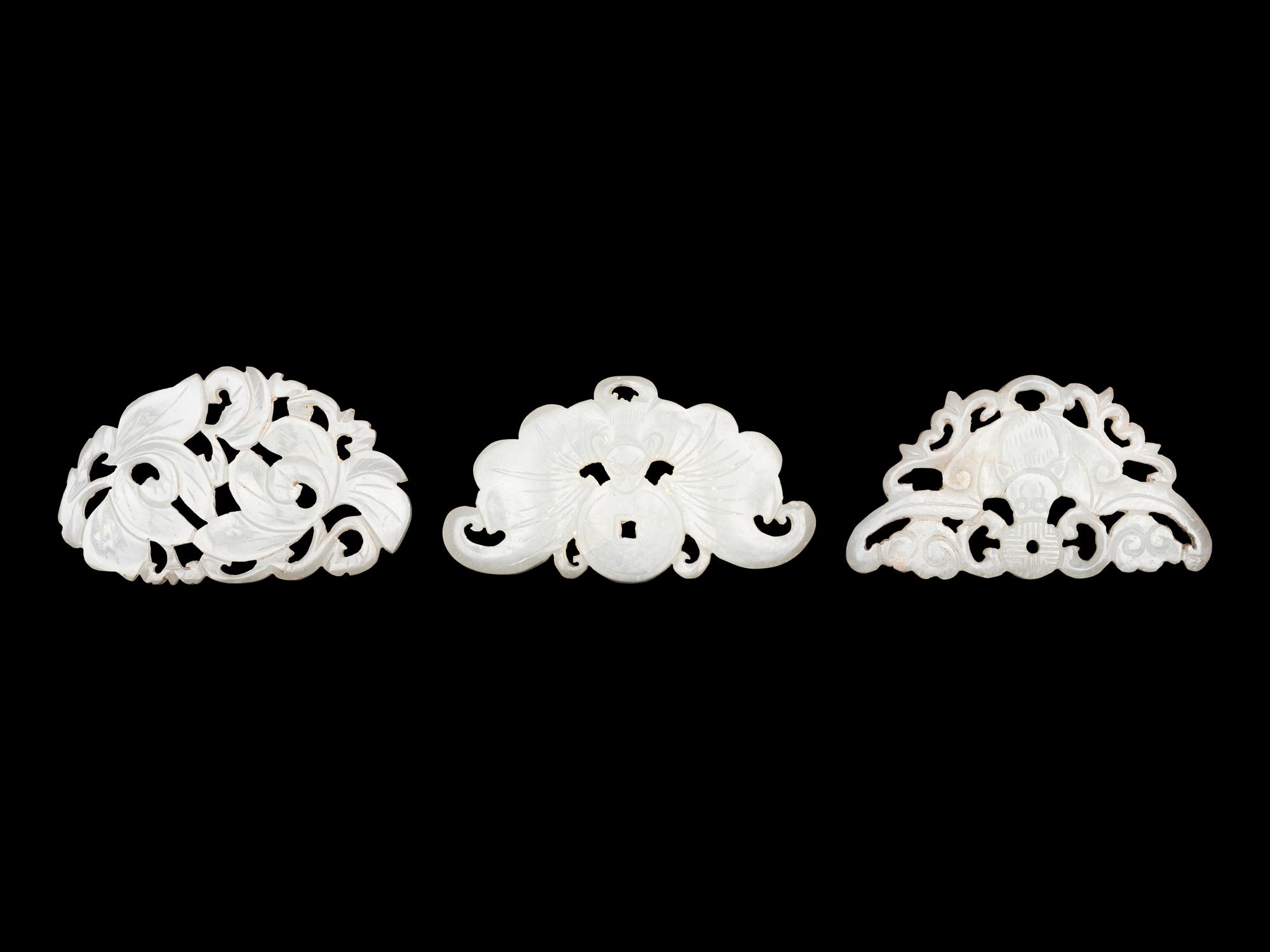 Three Chinese Pale Celadon Jade Reticulated Flori-Form Pendants
