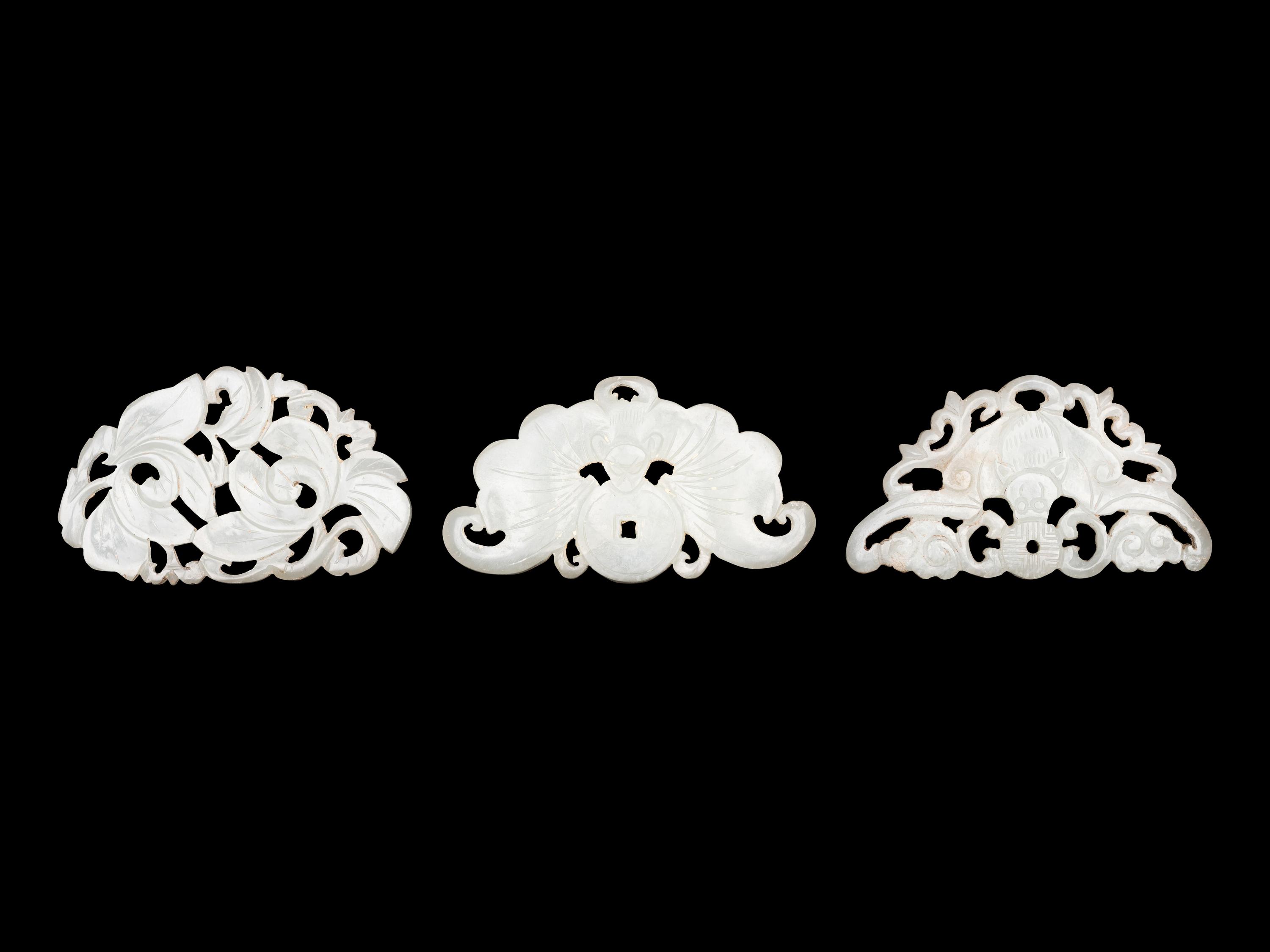 Three Chinese Pale Celadon Jade Reticulated Flori-Form Pendants