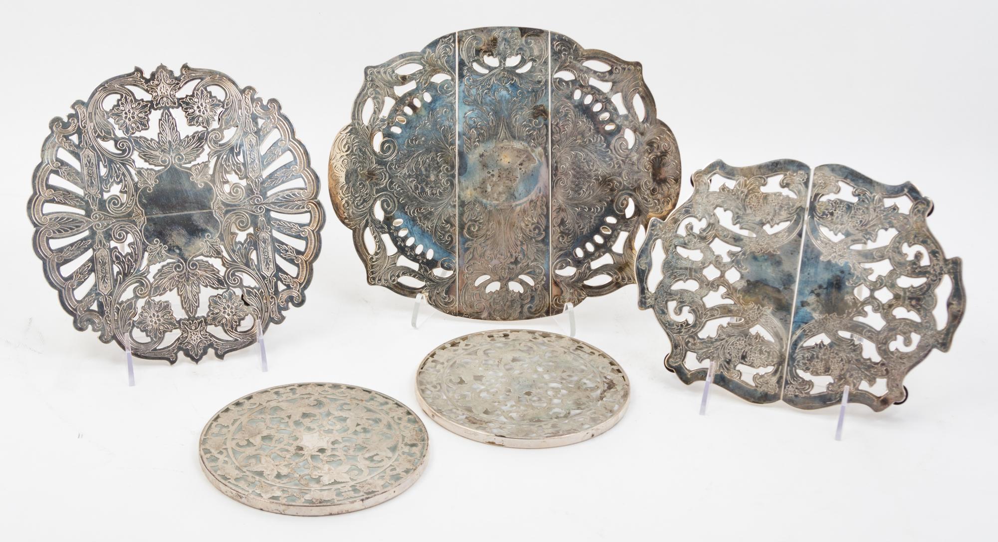 Three American Silver-plate Trivets, , each of extendable form with foliate decoration; together with two American silver mounted trive