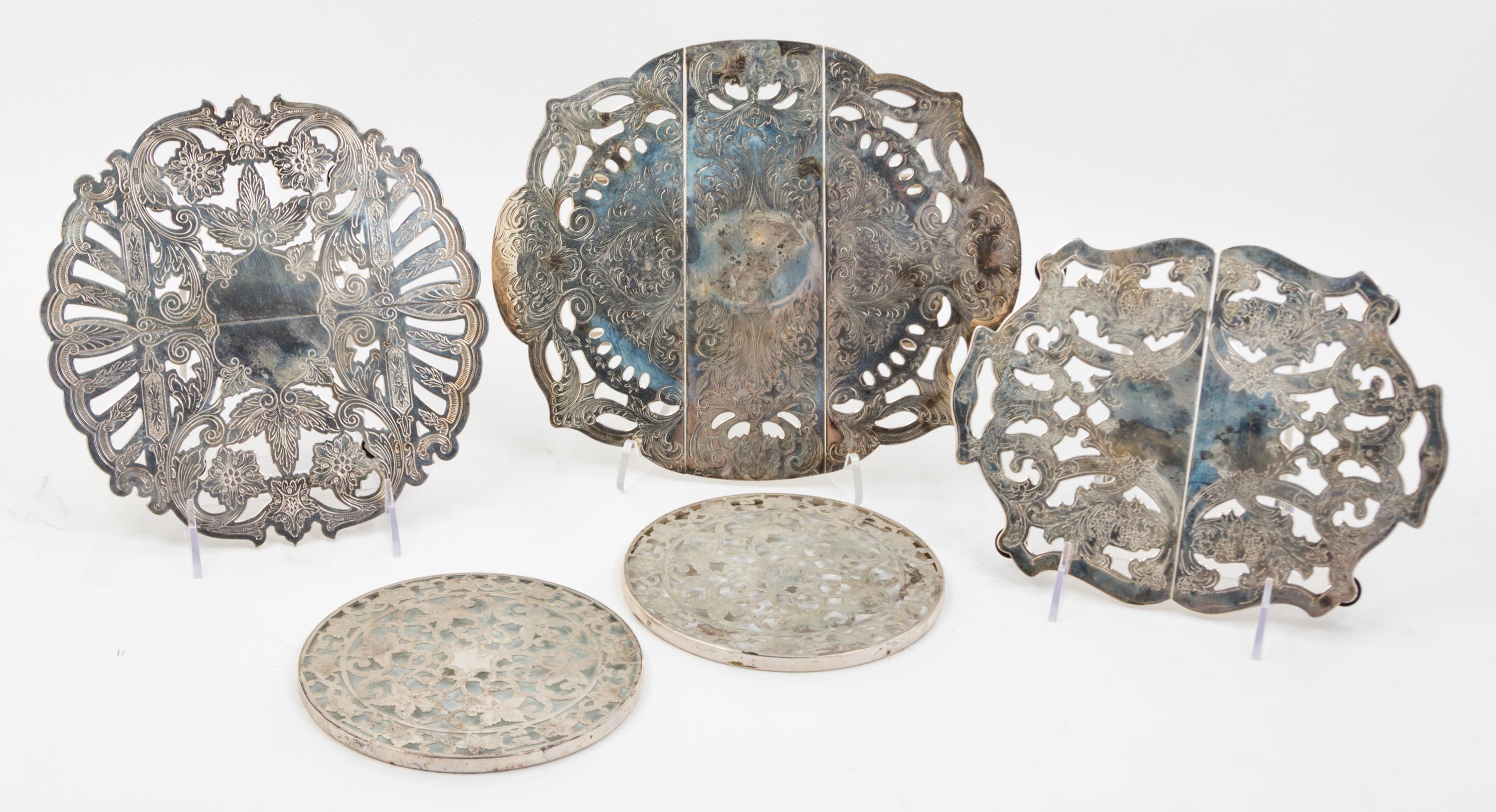 Three American Silver-plate Trivets, , each of extendable form with foliate decoration; together with two American silver mounted trive