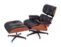 An Eames Laminated Walnut and Black Leather Lounge and Ottoman — FOR HERMAN MILLER