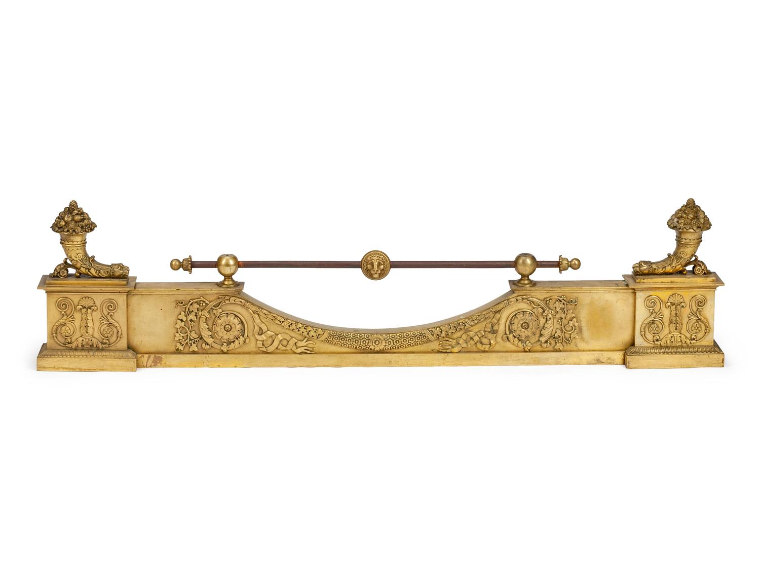 A Pair of Empire Gilt Bronze Chenets and a Fireplace Fender