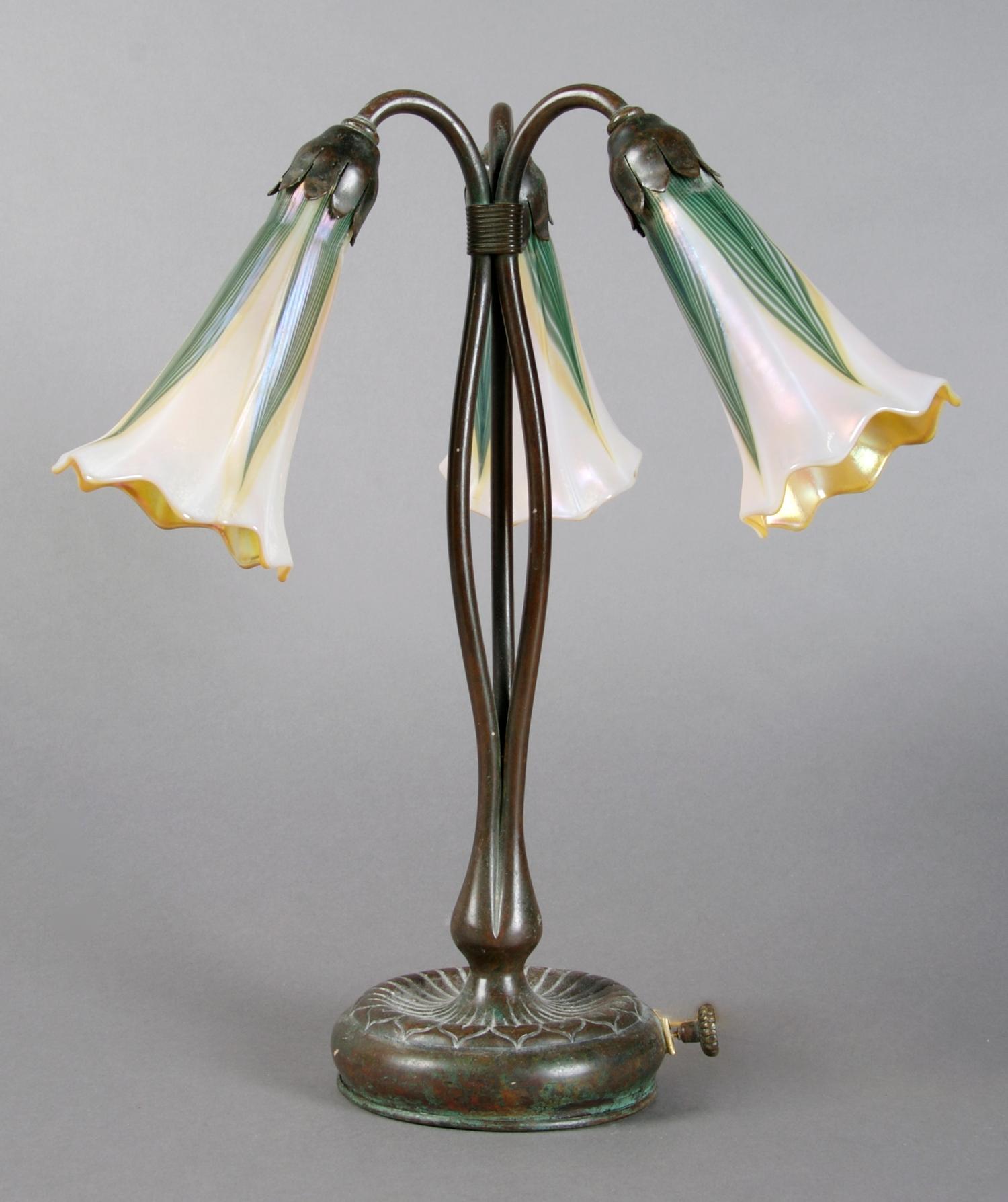 A Tiffany Studios Bronze Three-Light Lily Lamp, Height 13 inches.