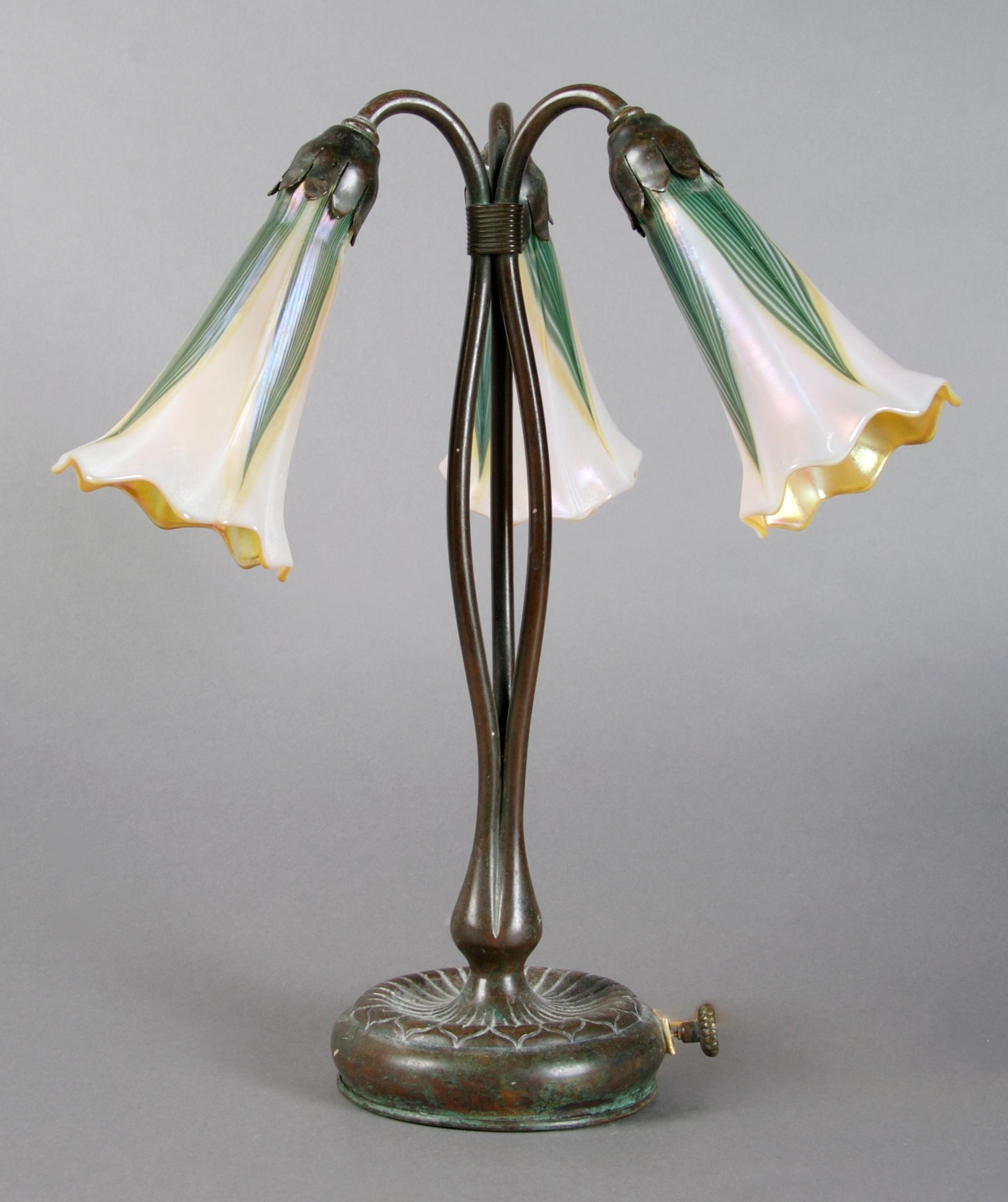 A Tiffany Studios Bronze Three-Light Lily Lamp, Height 13 inches.