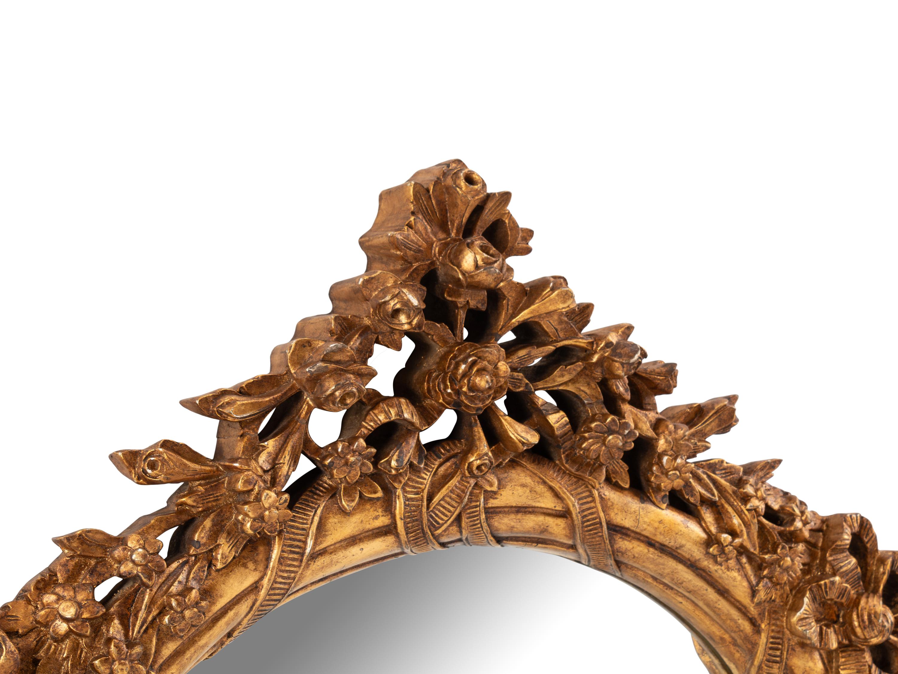 A Pair of Italian Carved Giltwood Oval Mirrors