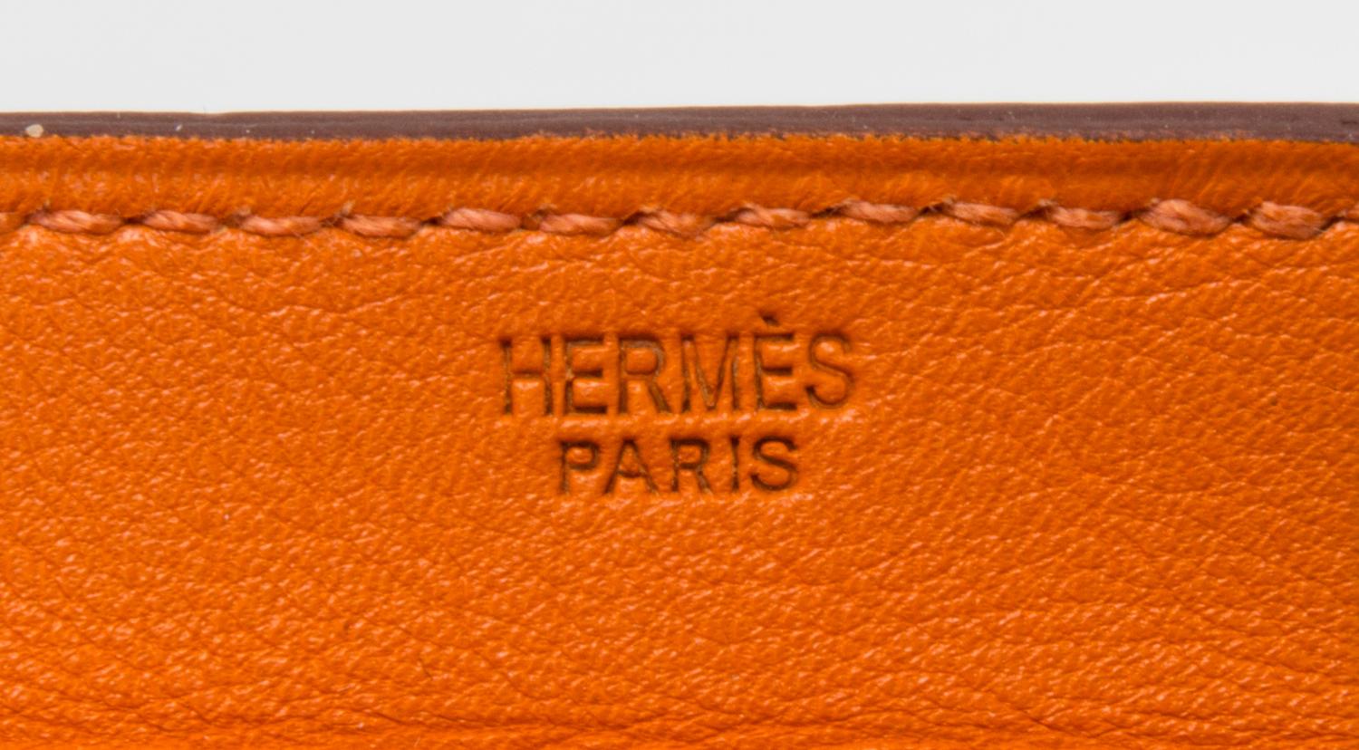 An Hermes Orange Leather Passport Pouch, 7" x 8" x 1".