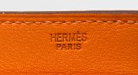 An Hermes Orange Leather Passport Pouch, 7" x 8" x 1".