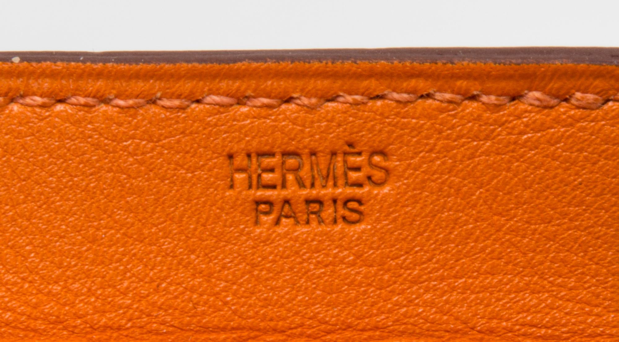 An Hermes Orange Leather Passport Pouch, 7" x 8" x 1".