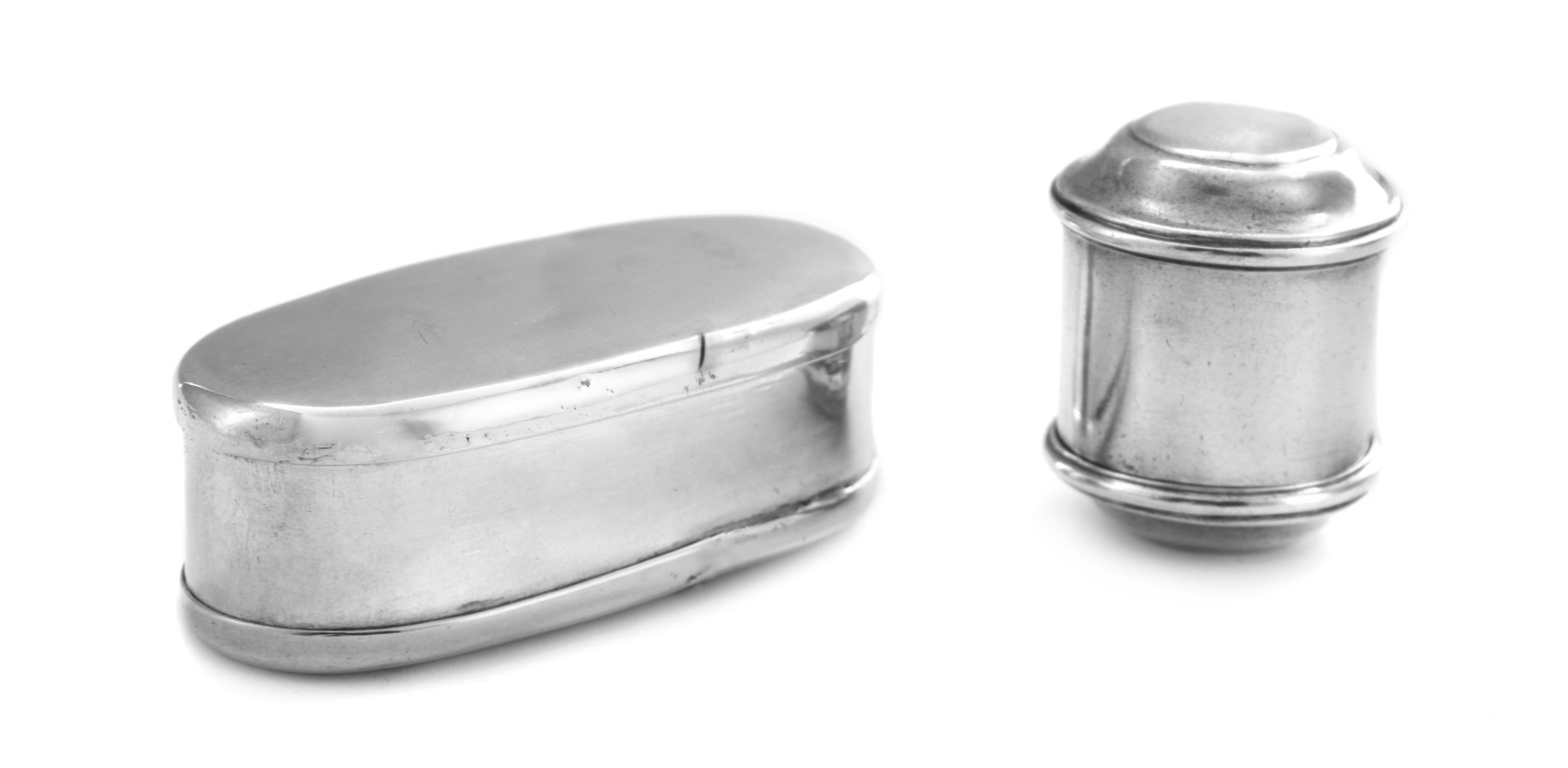 Two Silver Nutmeg Graters, , one of cylindrical form, the other of elongated oval form.