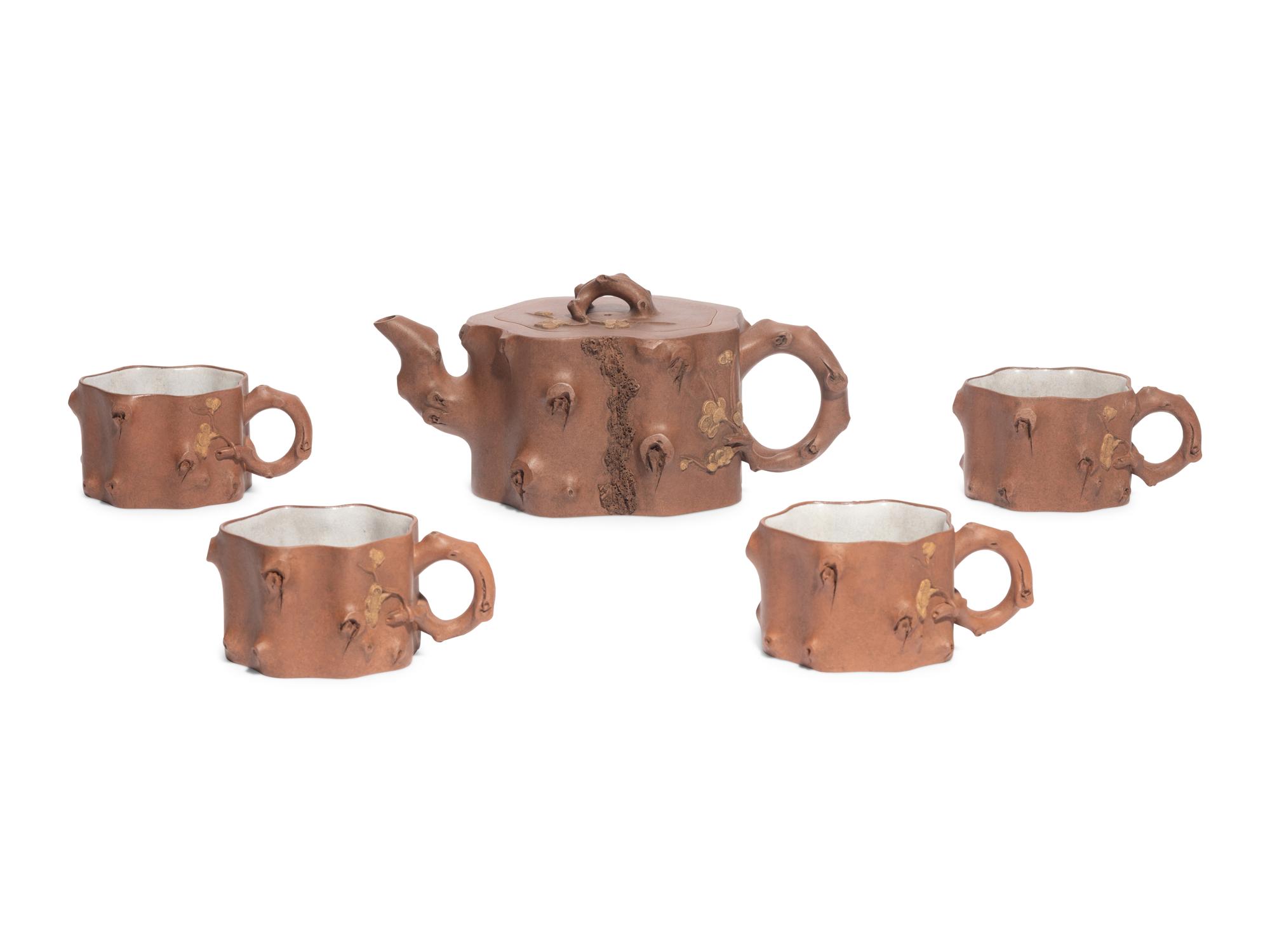 A Chinese Yixing Zisha Pottery Teapot and Four Teacups
