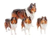 A Group of Four Royal Doulton Porcelain Collies Width of widest 10 1/2 inches.