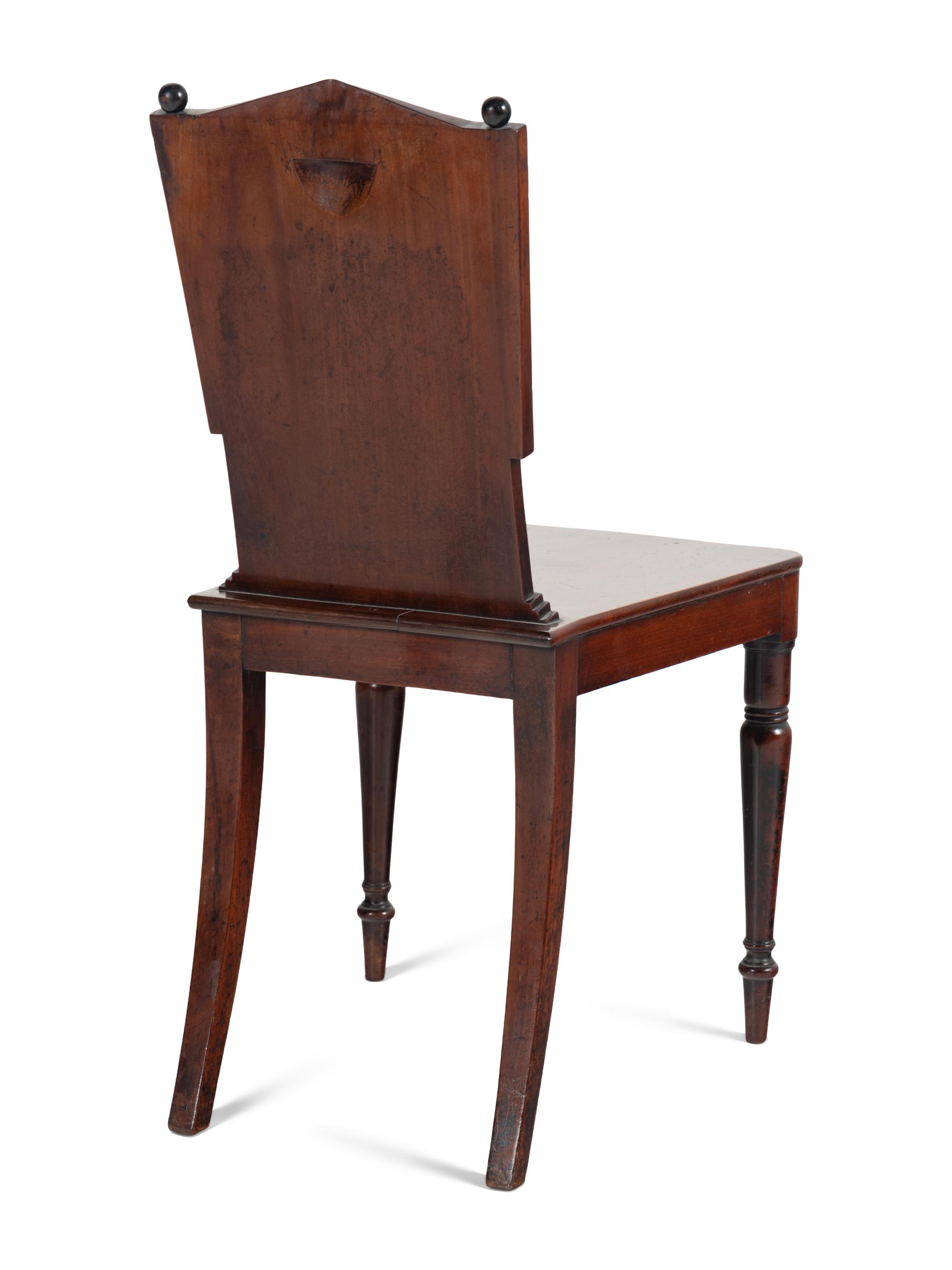 A Pair of William IV Carved Mahogany Hall Chairs