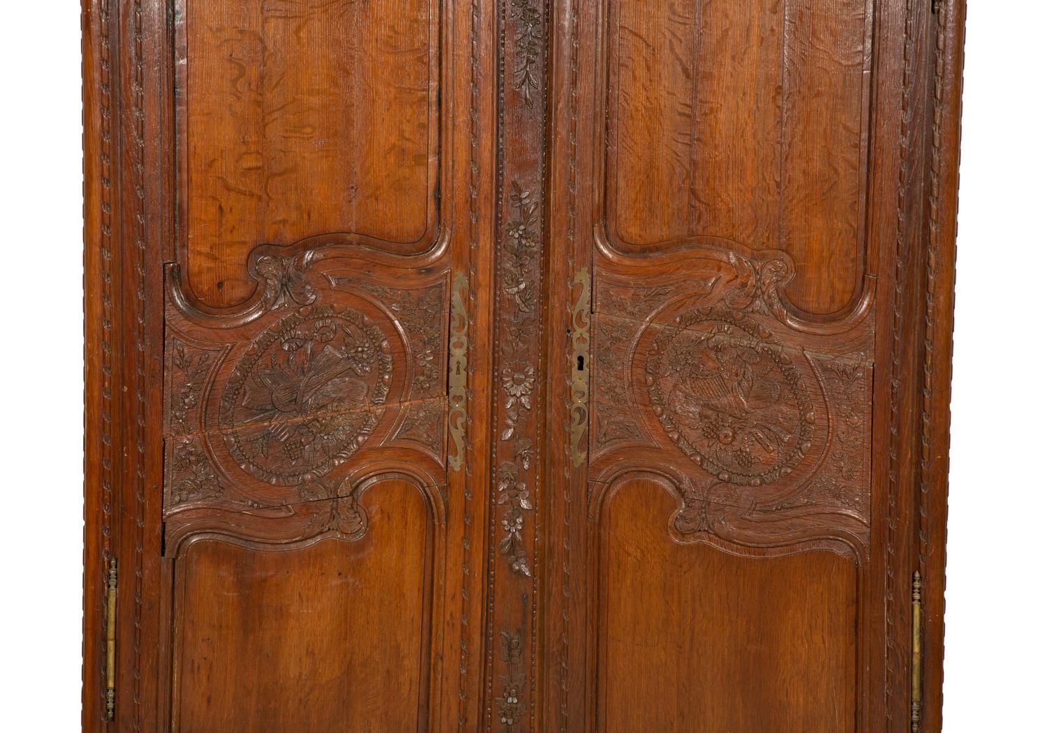 A French Provincial Carved Oak Armoire