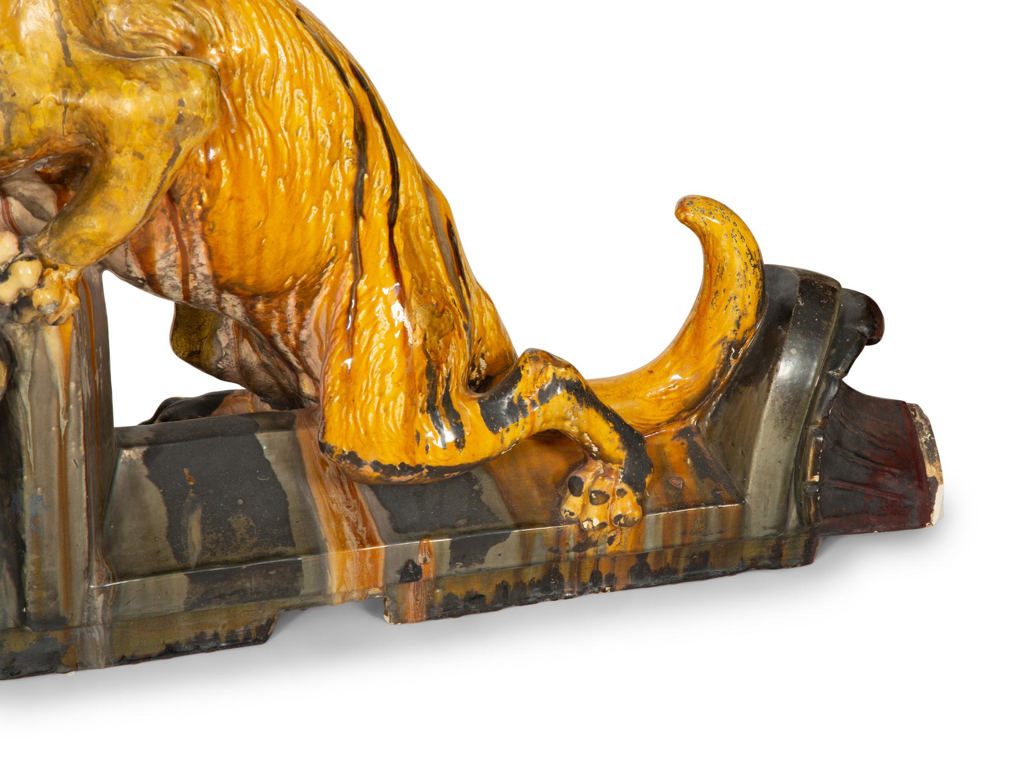 A Pair of Continental Glazed Terra Cotta Fox Roof Ornaments