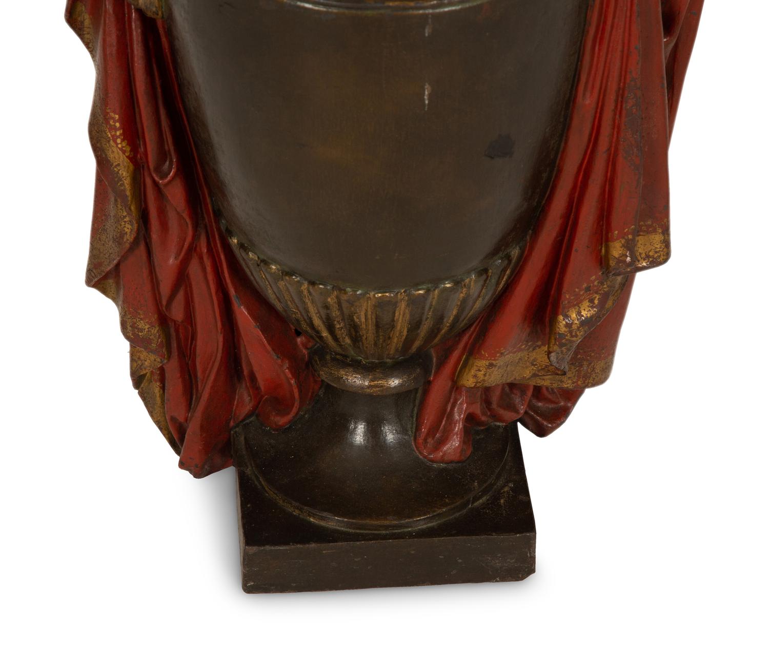 A Regency Style Painted and Parcel Gilt Cast Iron Urn