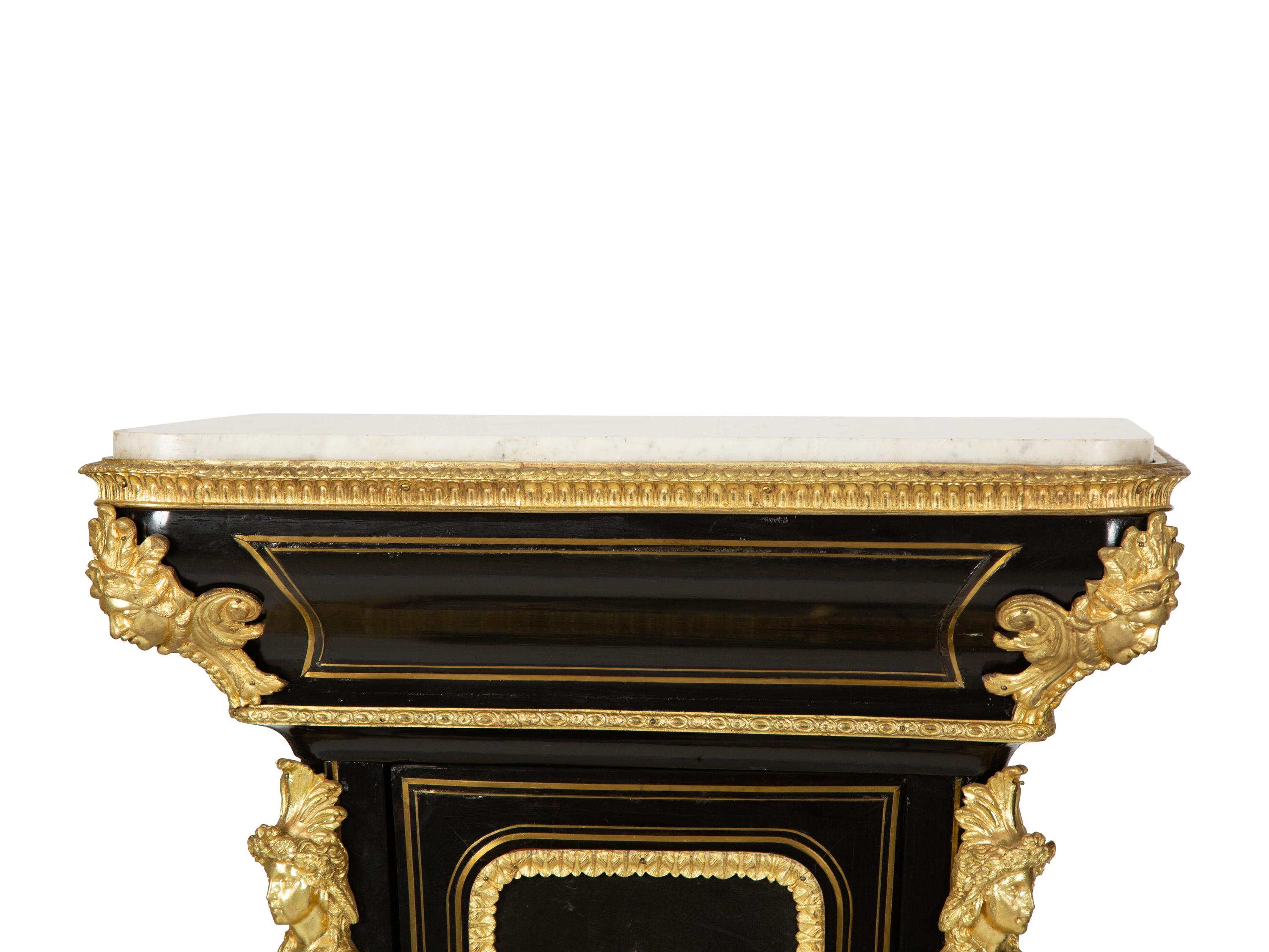 A Pair of Louis XVI Style Gilt-Bronze Mounted and Hardstone Inlaid Ebonized Marble-Top Pedestal Cabinets