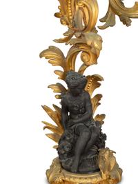 A Pair of Louis XV Style Gilt and Patinated Bronze Figural Six-Light Candelabra