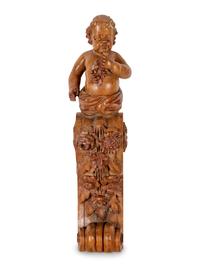 A Continental Carved Oak Figural Bracket in the Form of a Putto