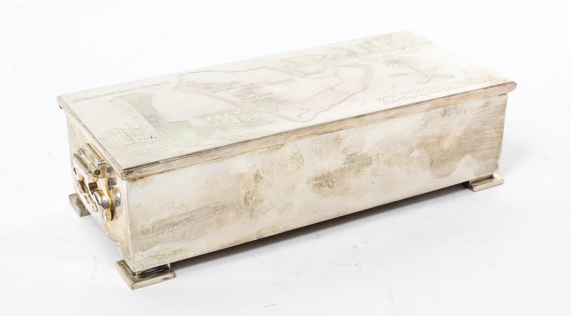 An English Silver Cigarette Box, Asprey & Co., London, 1985, decorated with the Saudi Arabian map and various symbols, having a fitted