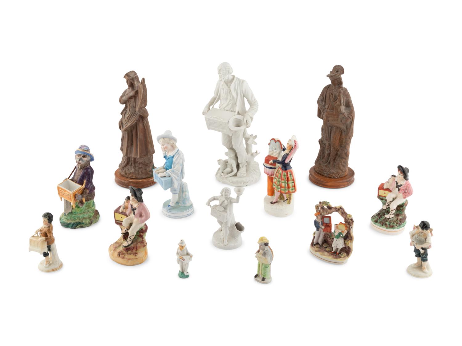 A Group of Fourteen Street Organist Figurines