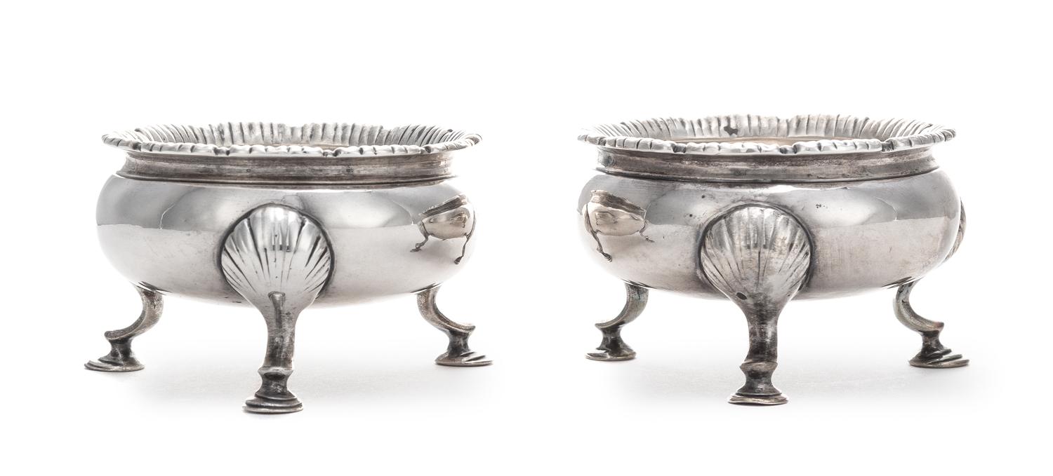 A Pair of George III Silver Salt Cellars, Stephen Adams II, London, 1767, each raised on three feet headed by shells.
