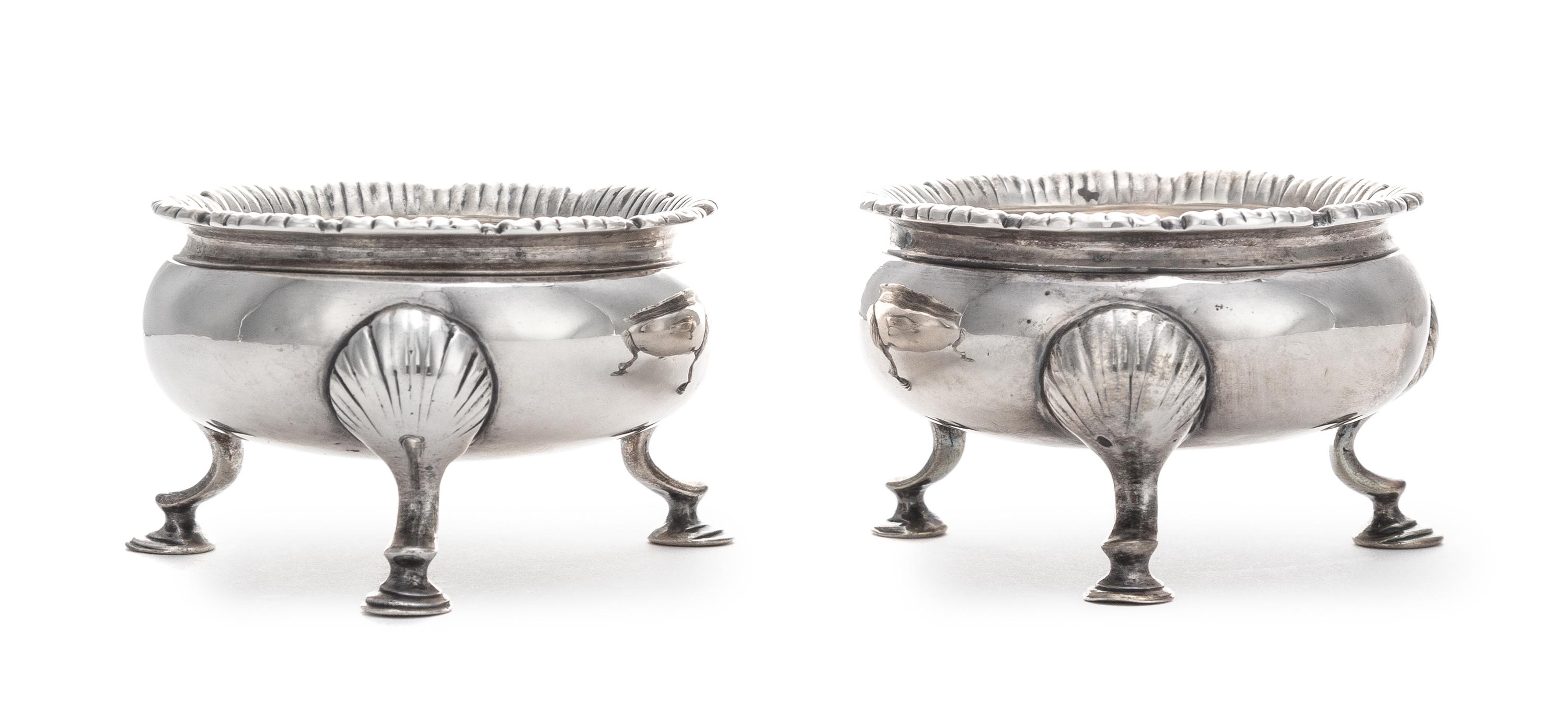A Pair of George III Silver Salt Cellars, Stephen Adams II, London, 1767, each raised on three feet headed by shells.