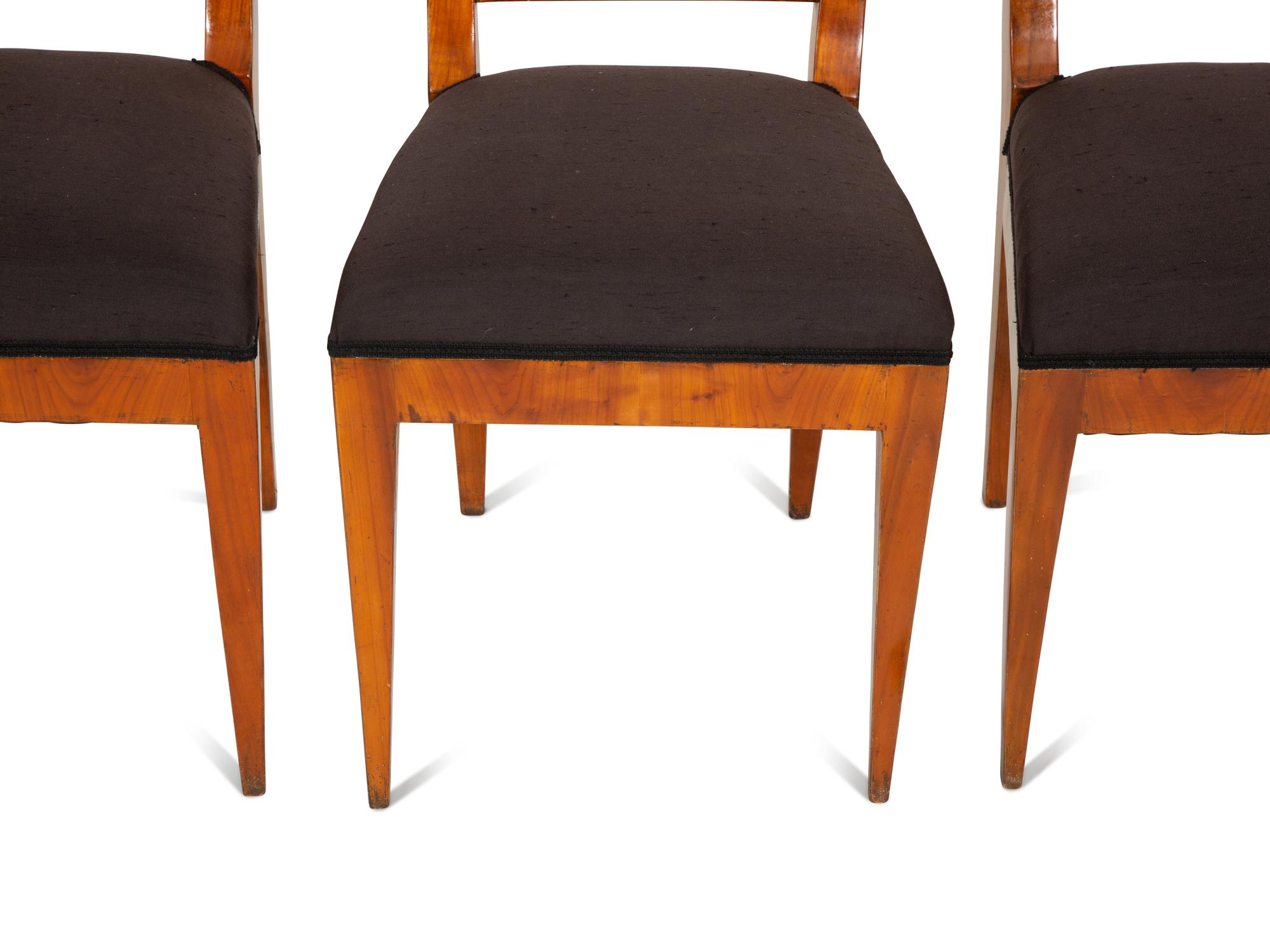 A Set of Four Biedermeier Part Ebonized Fruitwood Dining Chairs