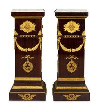 A Pair of Monumental Empire Style Gilt Bronze Mounted Mahogany Pedestals