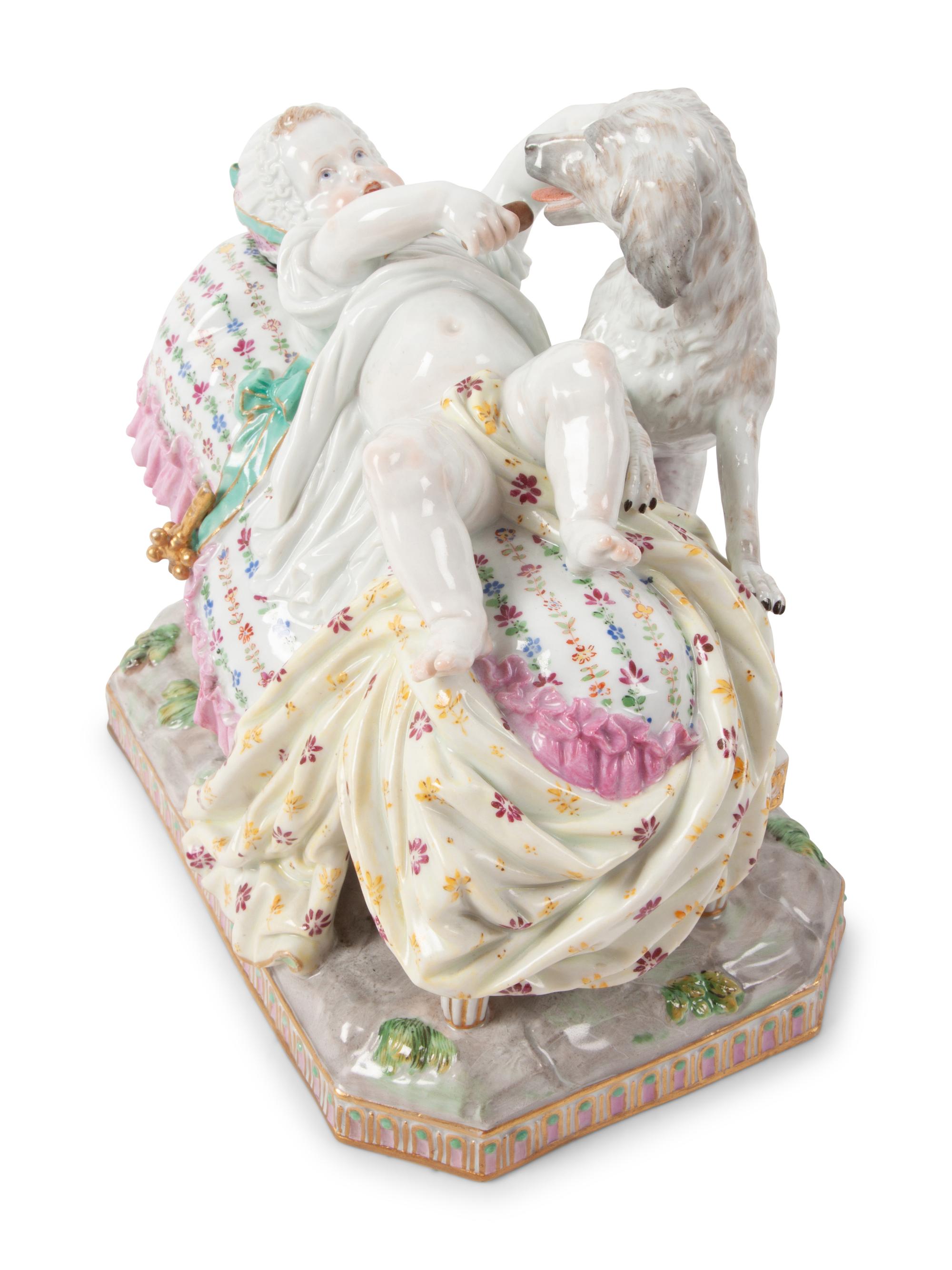 A Meissen Porcelain Figural Group of a Child in Bed with Dog