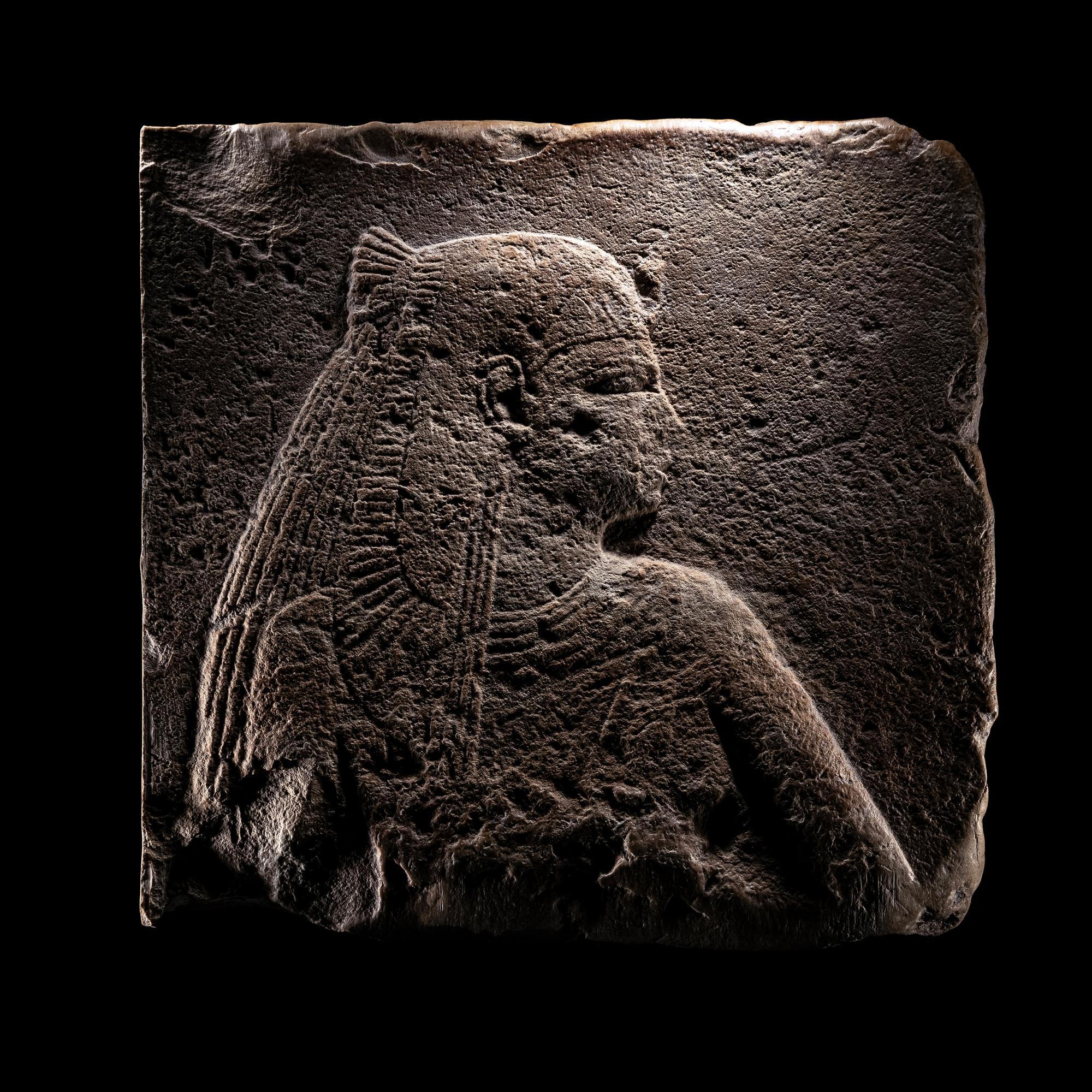 An Egyptian Stone Relief Fragment of a Female Pharaoh or Goddess