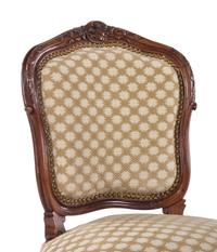 A Set of Four Louis XV Style Carved Walnut Chairs