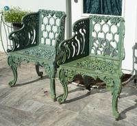 A Green-Painted Metal Garden Bench and Pair of Armchairs