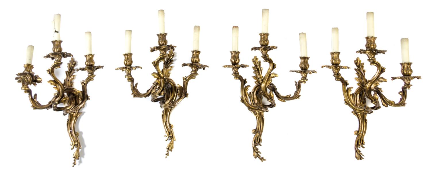 A Group of Four Louis XV Style Gilt Bronze Three-Light Wall Sconces Height 24 inches.