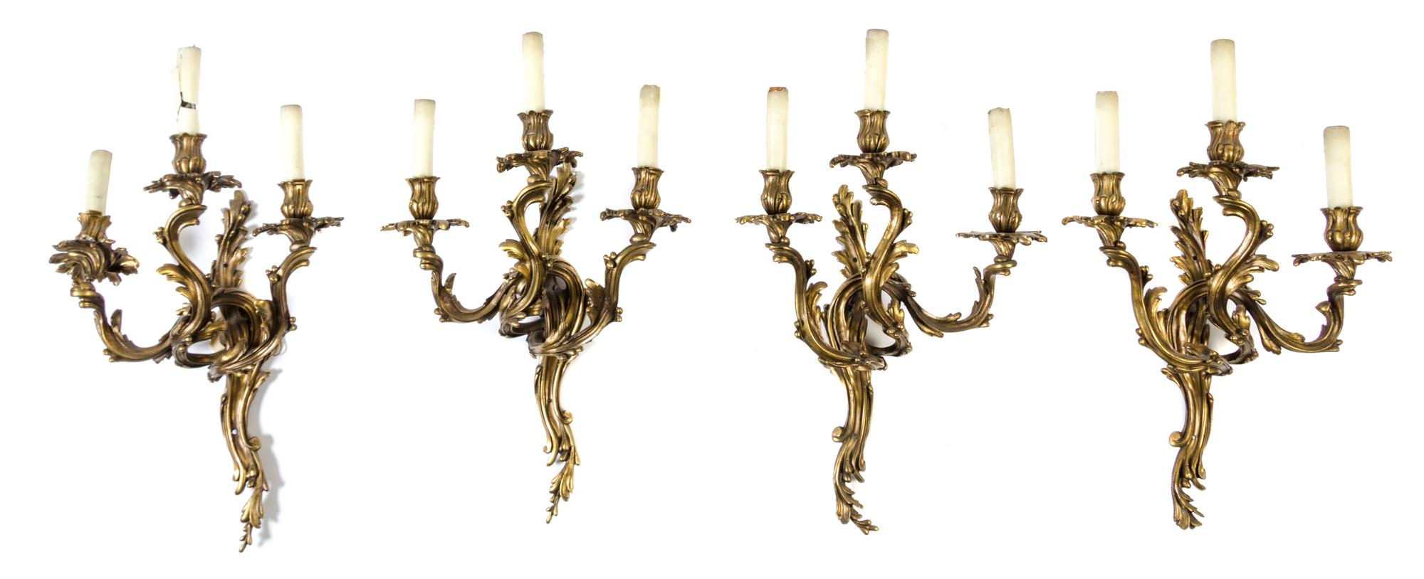 A Group of Four Louis XV Style Gilt Bronze Three-Light Wall Sconces Height 24 inches.