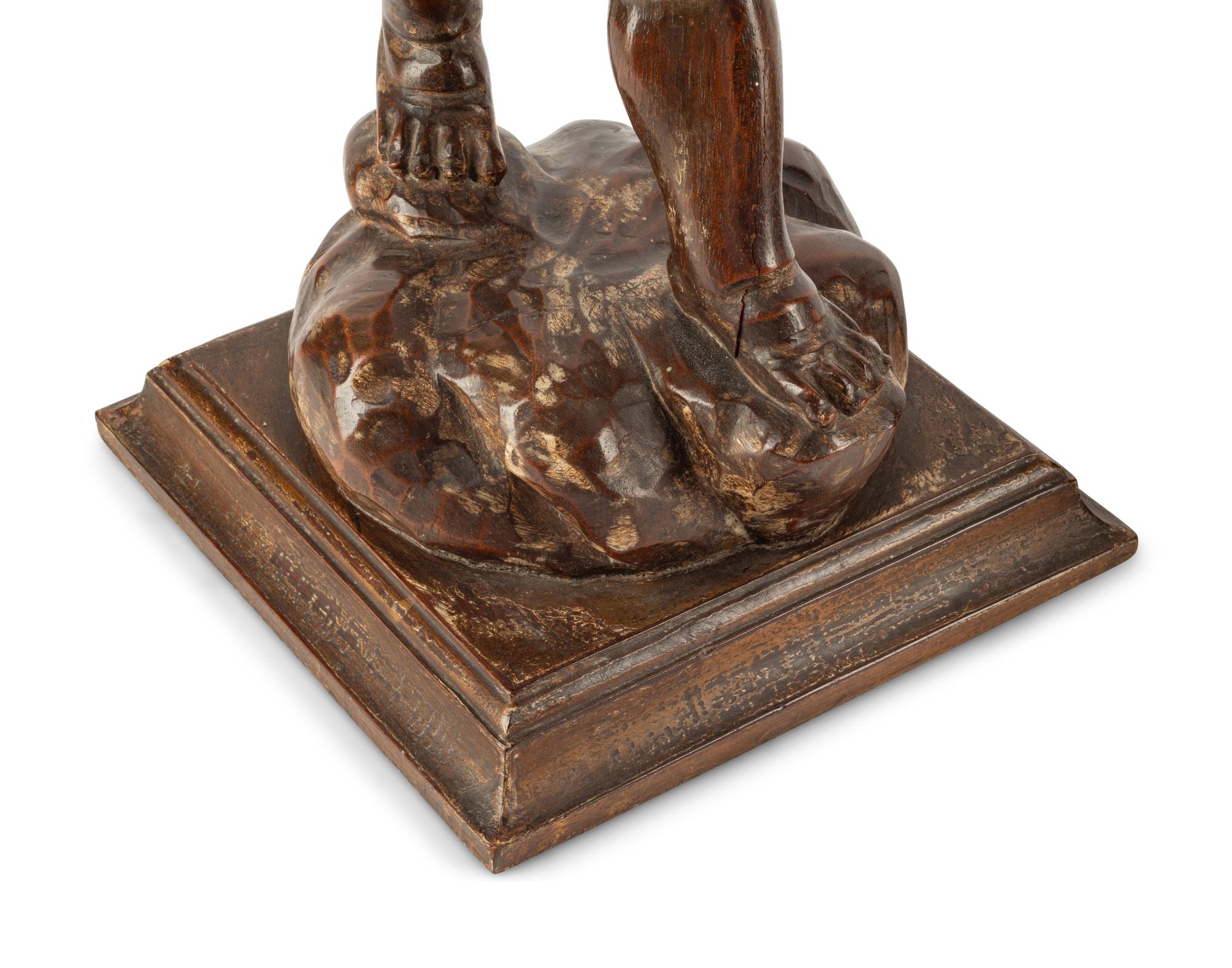 A Pair of Continental Carved Walnut Figures of Putti