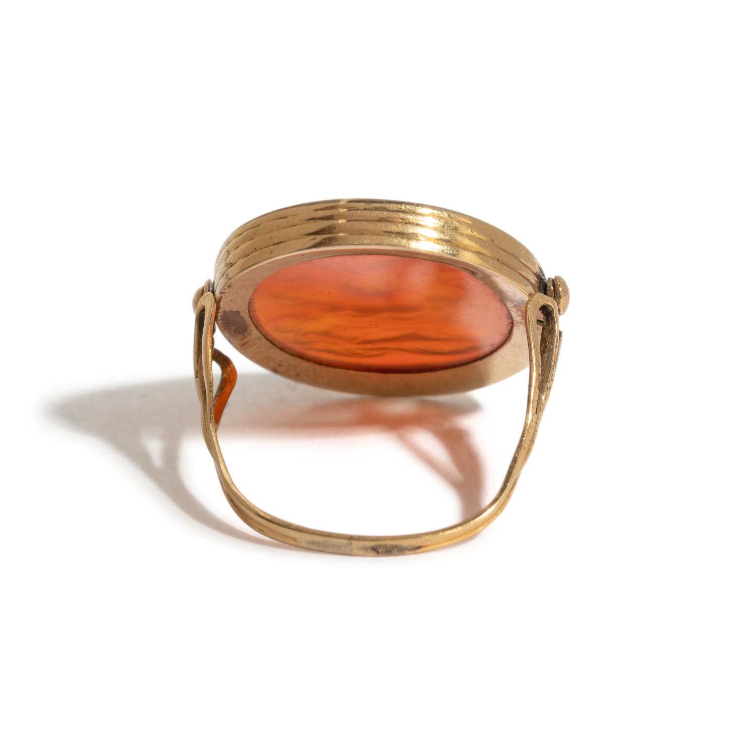 A Neoclassical Gold and Carnelian Finger Ring with the God Zeus, a Reclining Female, and a Greek Inscription