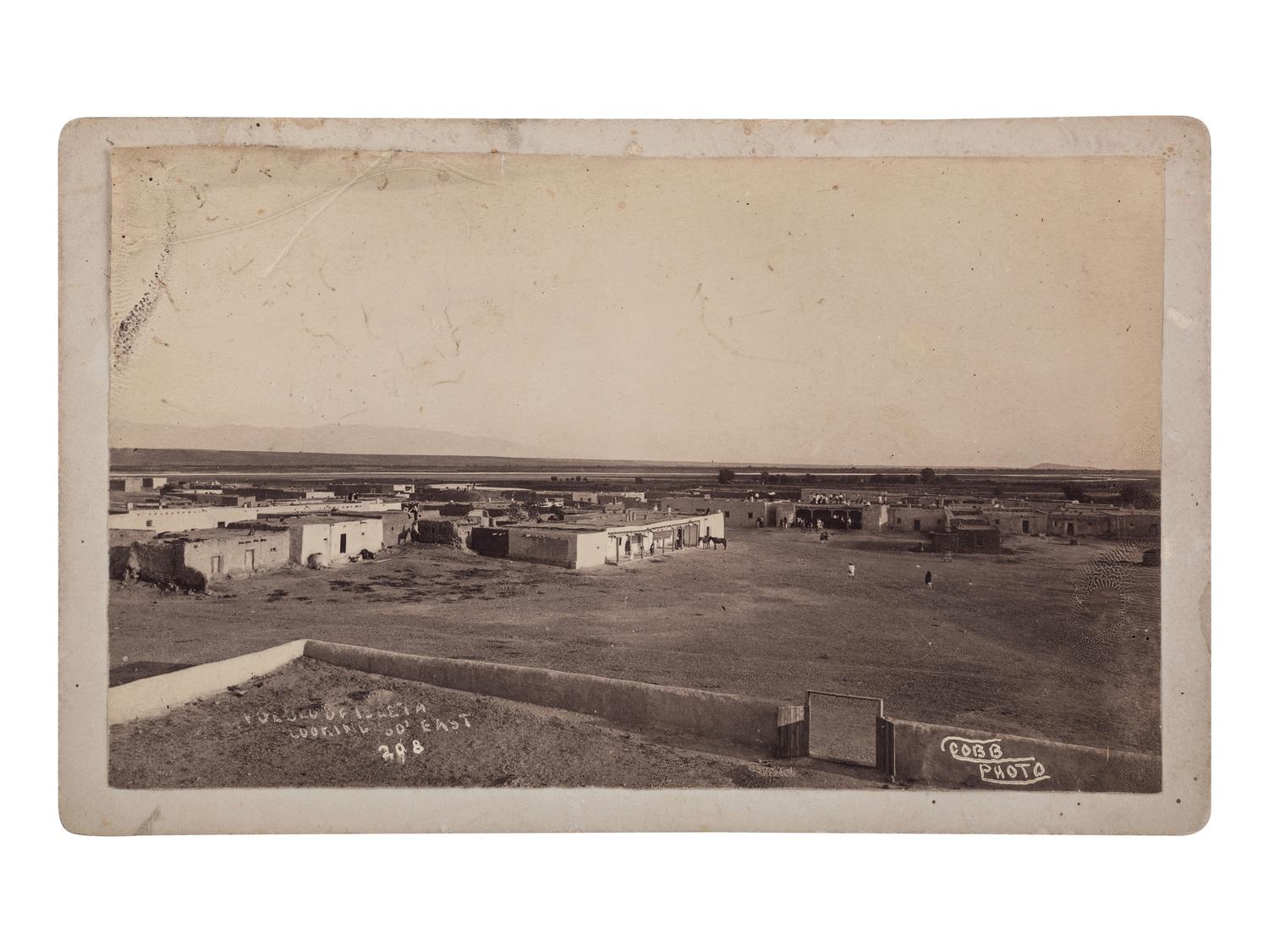 [NEW MEXICO]. A group of 2 photographs, incl. view of Pueblo Of Isleta Looking So’ East and Pueblo Indians gambling. Ca 1880s.