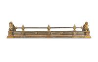 An Empire Style Brass and Steel Fire Fender with Recumbent Lions