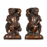 A Pair of Continental Painted Composition Figural Wall Ornaments