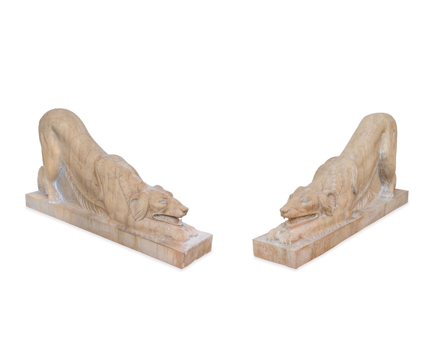 A Pair of Carved Marble Crouching Dogs — 20TH CENTURY