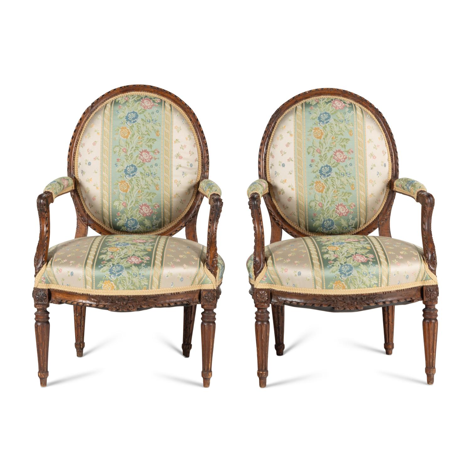 A Pair of Louis XVI Carved Walnut Fauteuils